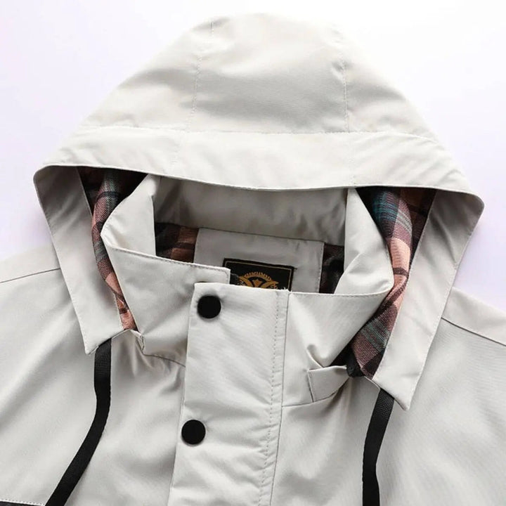 Versatile men's hooded quilted jacket; waterproof, windproof, great for travel & casual wear.
