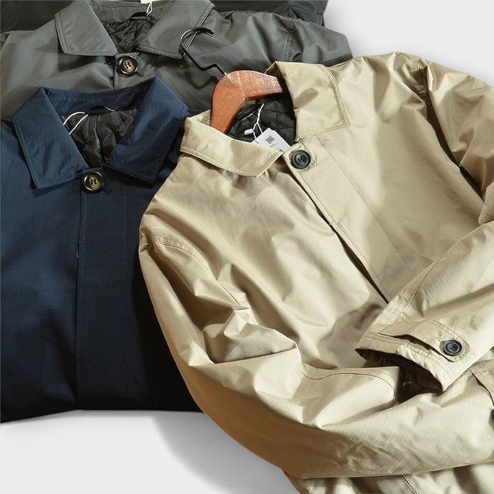 Everyday men's fall/winter outerwear: an insulated long coat with weatherproof fabric and button closure.
