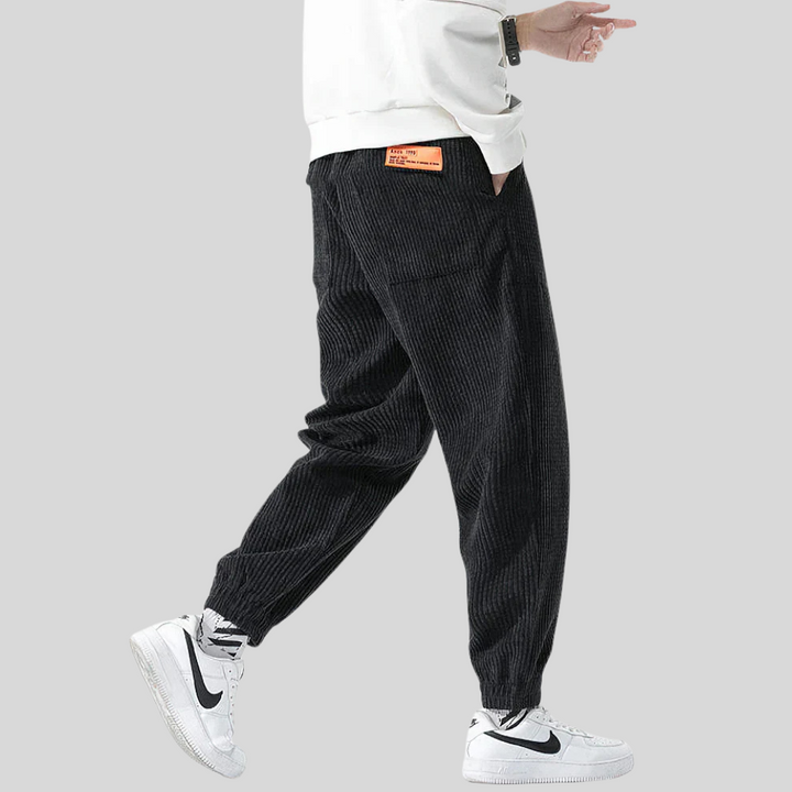 Gray wide-leg corduroy joggers for men, offering ultimate comfort and a textured, fashionable look. Relaxed fit.