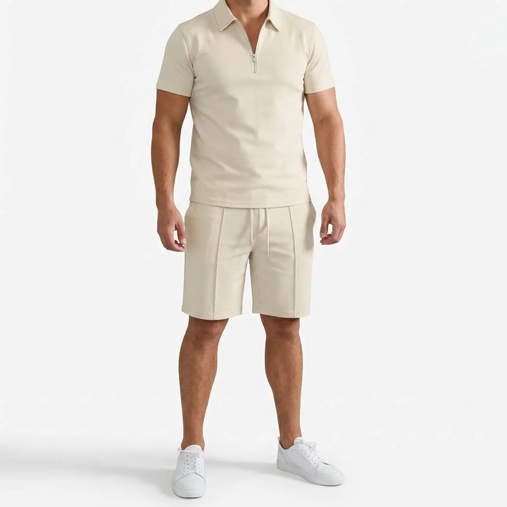 Man models a men's zip neck polo and drawstring shorts set, perfect casual fashion for summer.