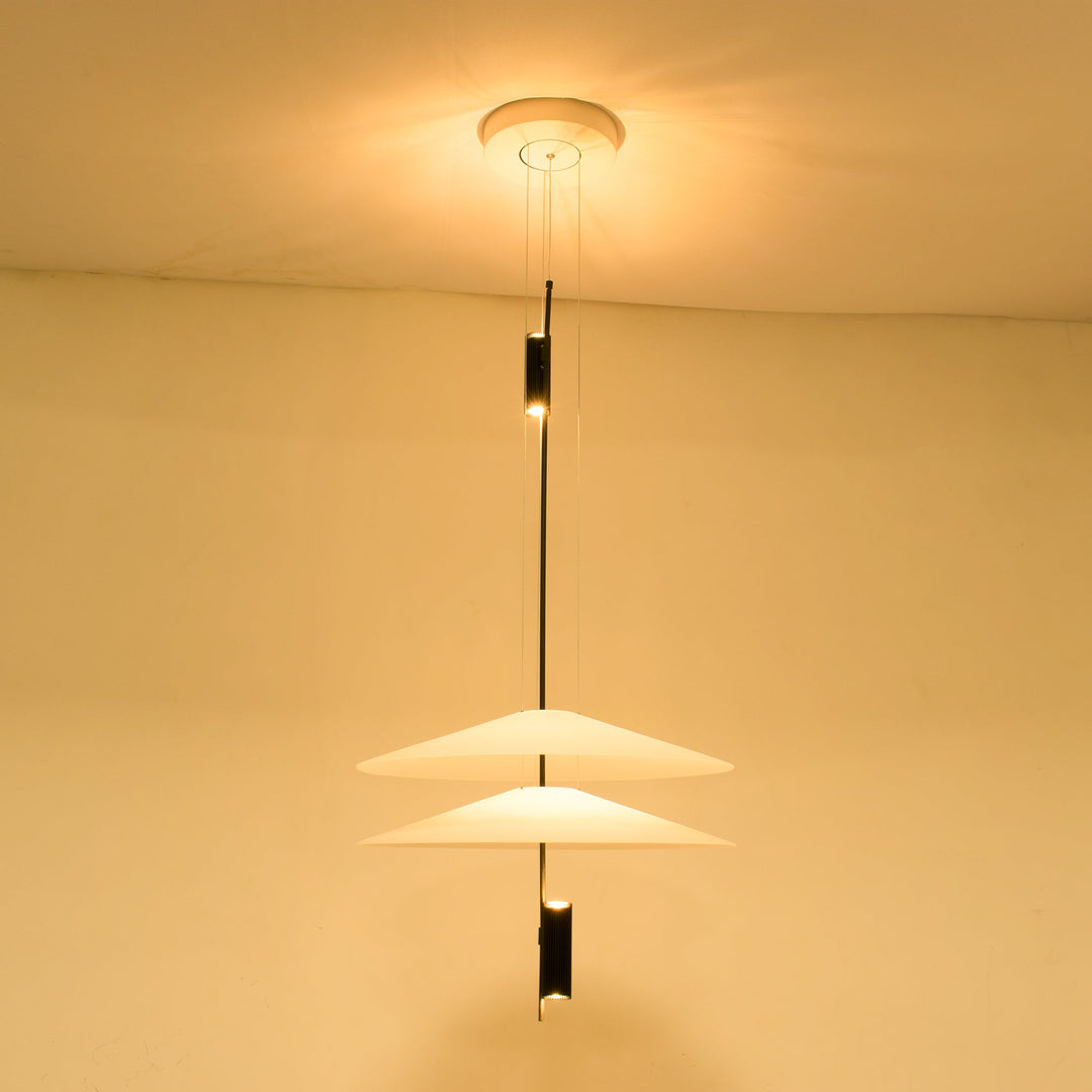 Wide shot of Merru black sculptural LED pendant light illuminating a dining area.