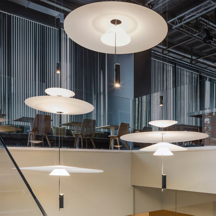 Black Merru LED disc pendant light, perfect for a high-ceiling living room.