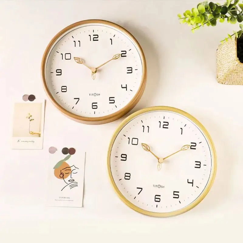 Close-up of a cream & brown minimalist wooden wall clock, showing wood grain.