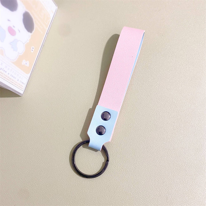 Handcrafted minimalist leather keychain, highlighting durable material and sleek design.