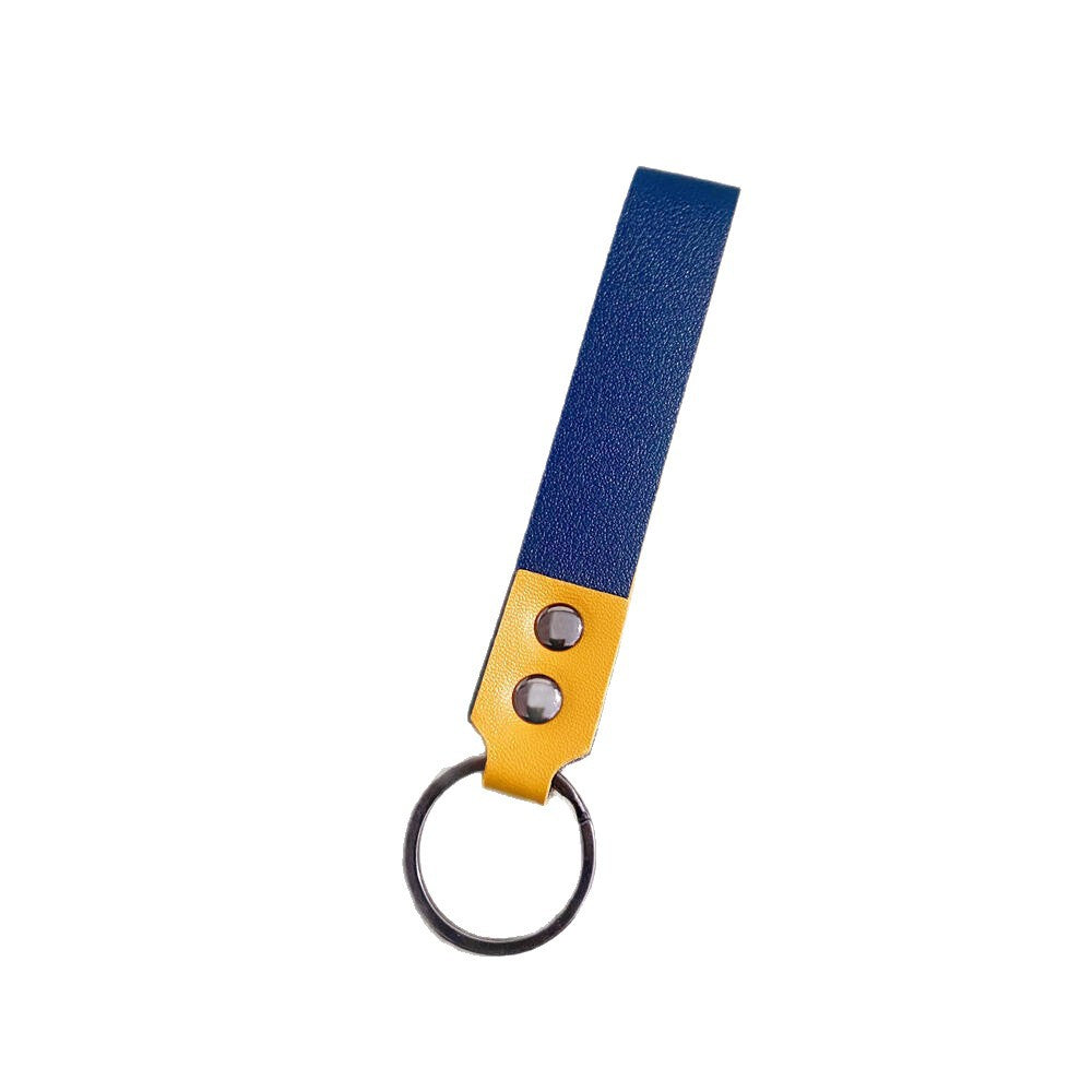 Close-up of a minimalist genuine leather keychain, showcasing fine grain and craftsmanship.