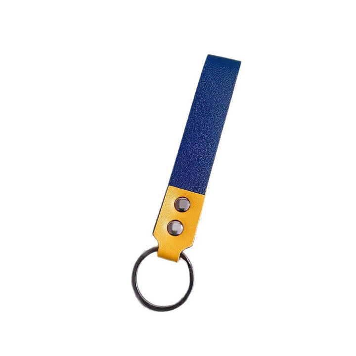 Close-up of a minimalist genuine leather keychain, showcasing fine grain and craftsmanship.