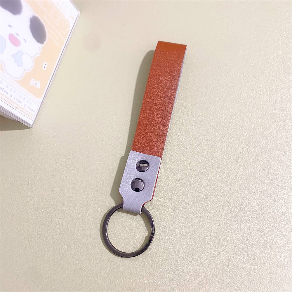 Assorted minimalist leather keychains in various colors, stylish key holders for unisex use.