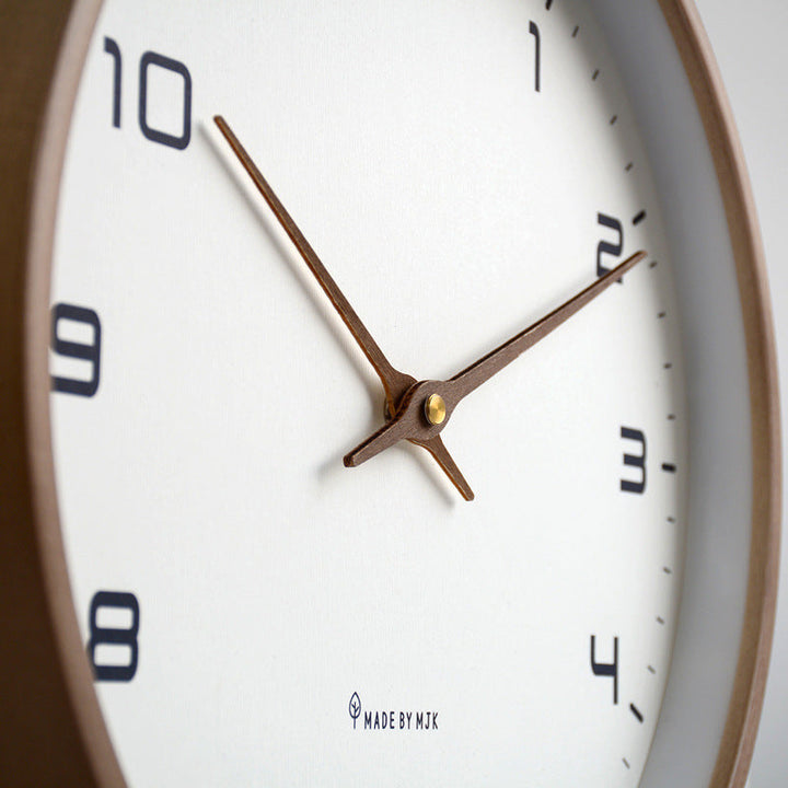 Stylish minimalist wall clock with wooden frame, a silent and decorative accent for modern home decor.
