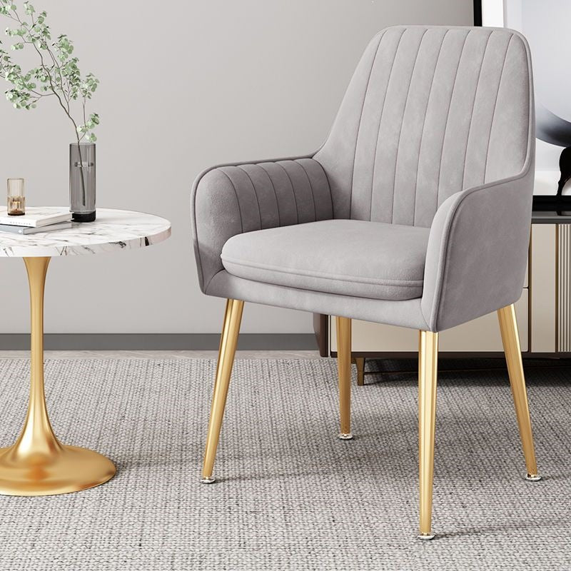 Modern compact chair with sleek gold legs, perfect for contemporary homes.