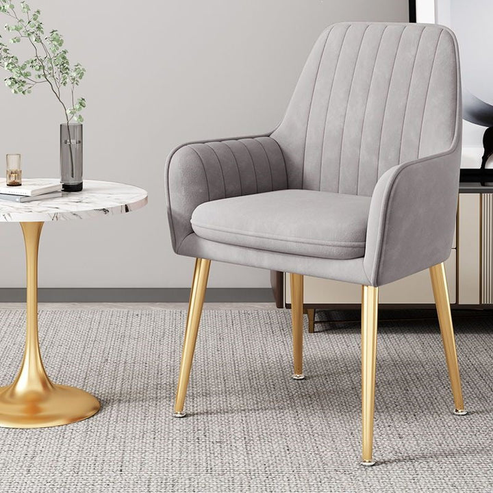 Modern compact chair with sleek gold legs, perfect for contemporary homes.
