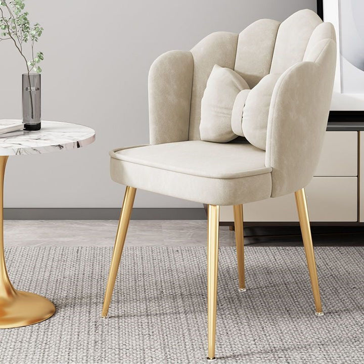 Green accent chair with polished gold legs, adding a pop of color to decor.