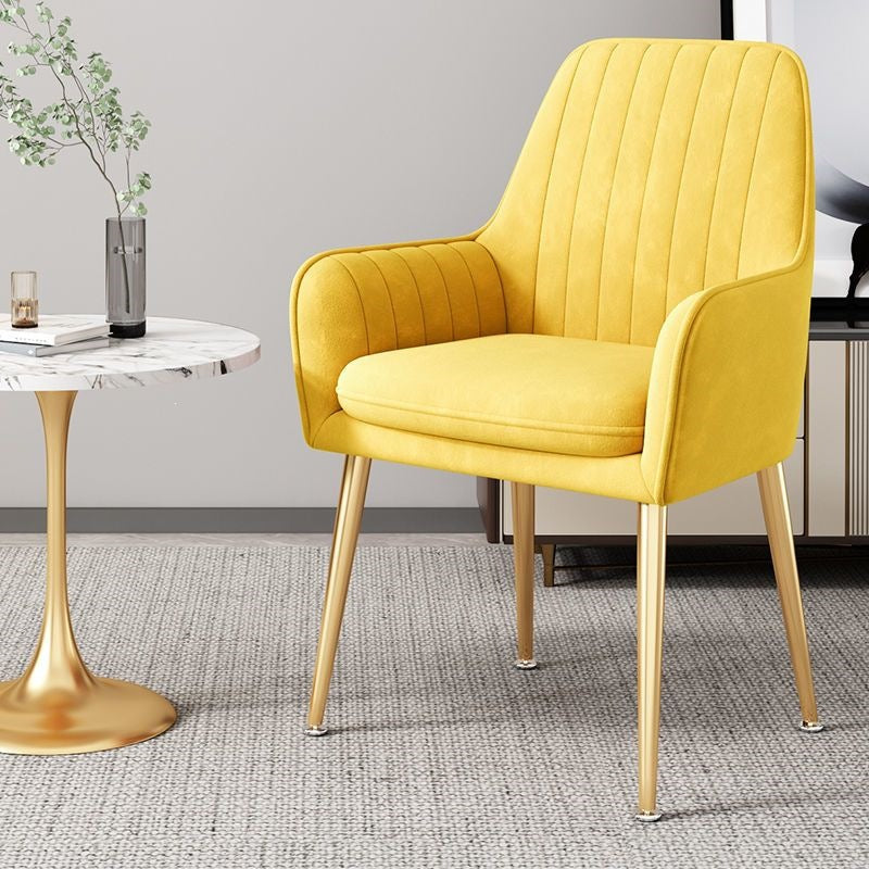 Stylish accent chair with gold legs, complementing various interior styles.