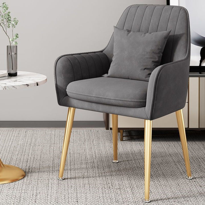 Luxurious accent chair, gold finish legs, embodying modern elegance.