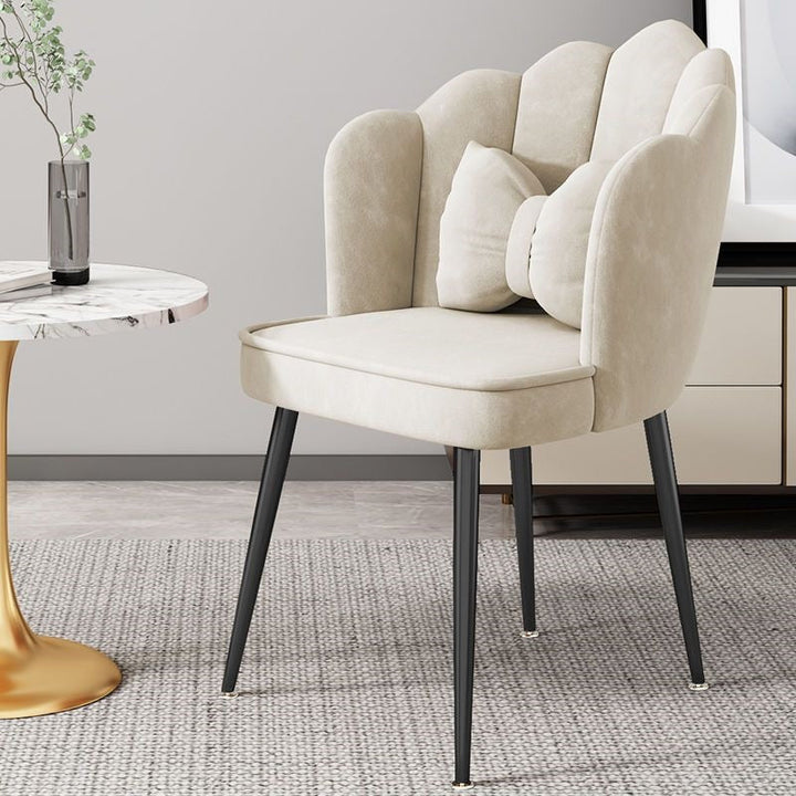 Decorative accent chair, gold legs, enhancing the aesthetic appeal of a room.