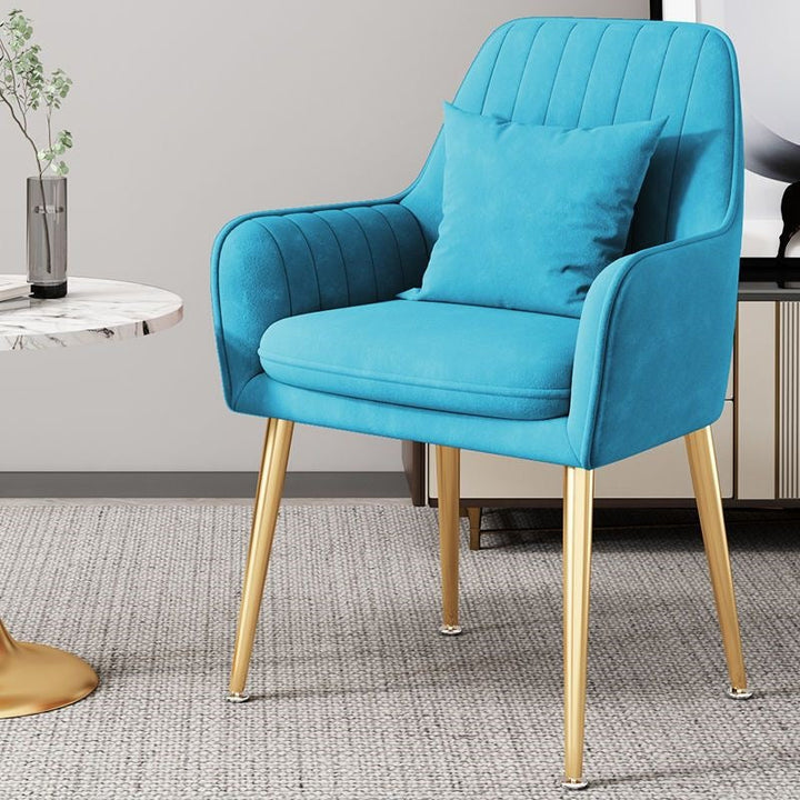 Plush accent chair, elegant gold legs, creating a cozy and inviting space.