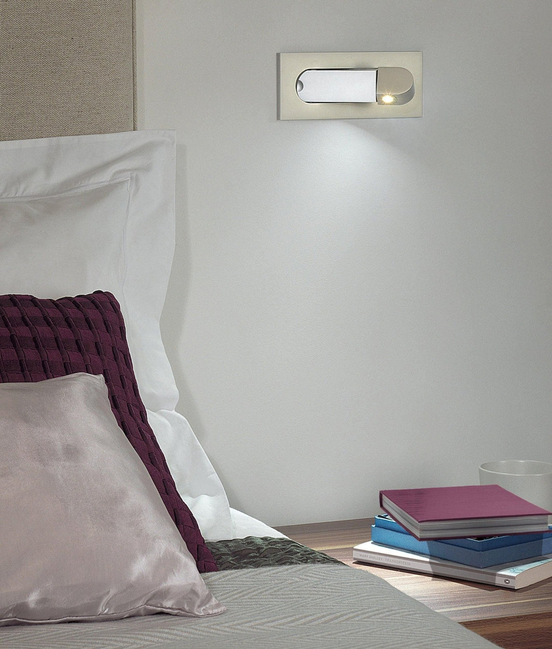 Contemporary LED directional reading light, adjustable for precise illumination in bedrooms.