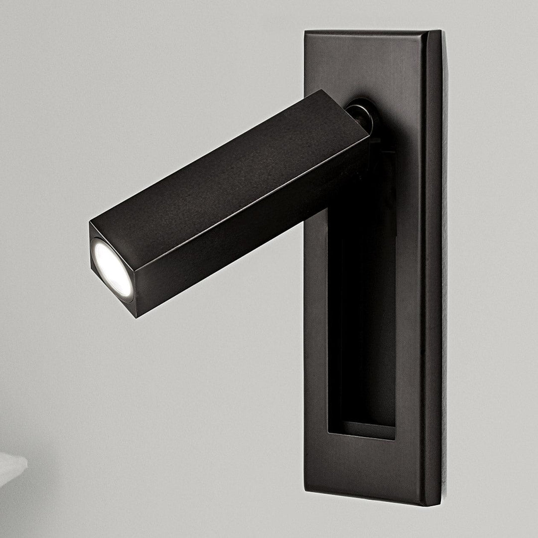 Modern adjustable LED wall light for bedside reading, dimmable for bedroom ambiance.