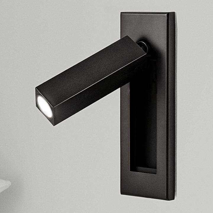 Modern adjustable LED wall light for bedside reading, dimmable for bedroom ambiance.