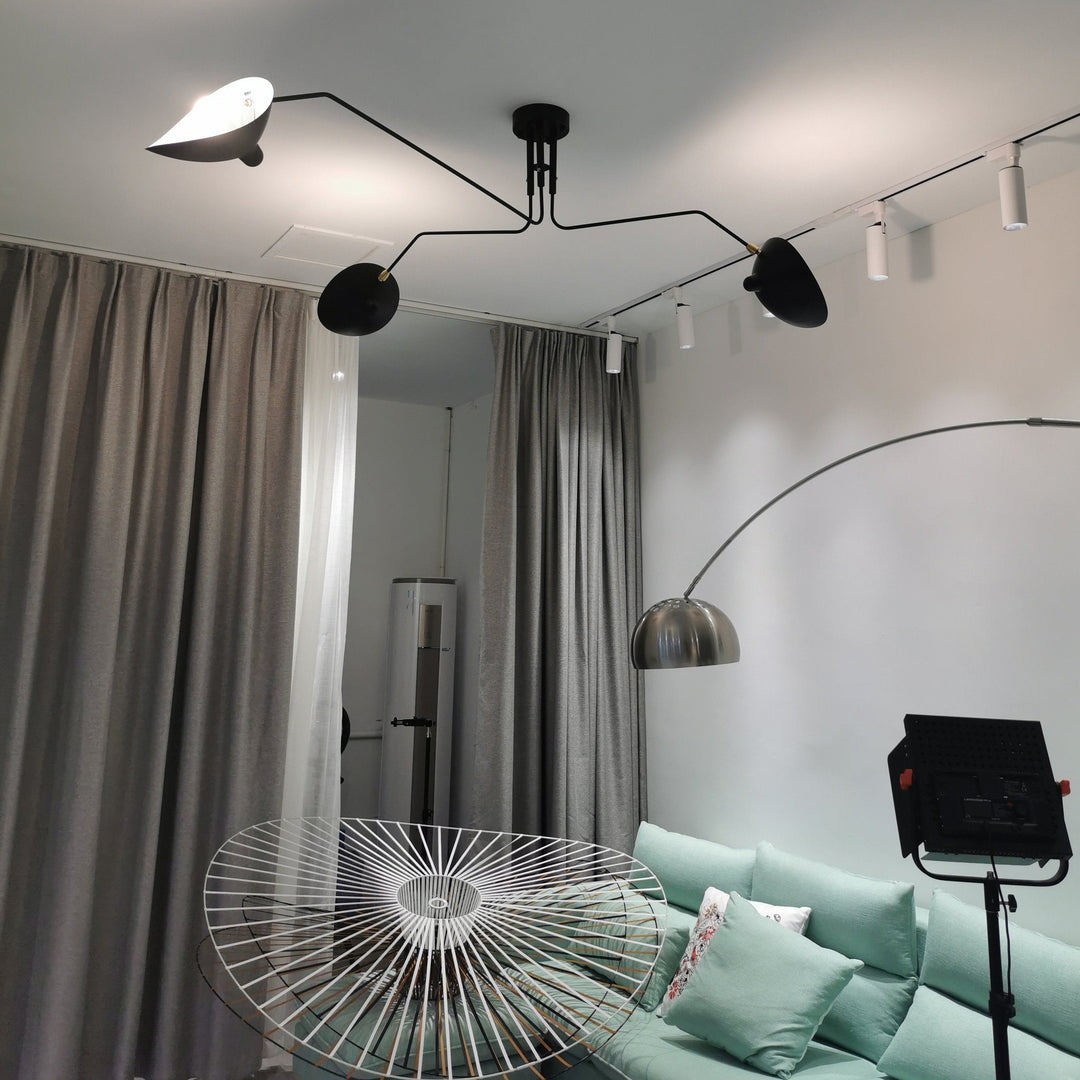 Minimalist adjustable multi-arm ceiling light, sleek metal design for modern bedrooms.