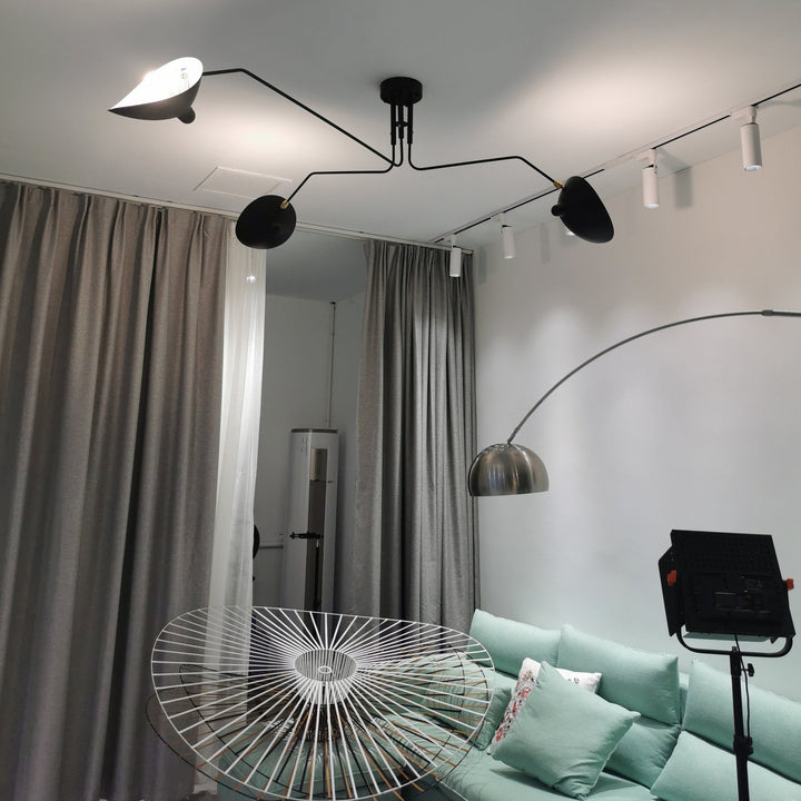 Minimalist adjustable multi-arm ceiling light, sleek metal design for modern bedrooms.