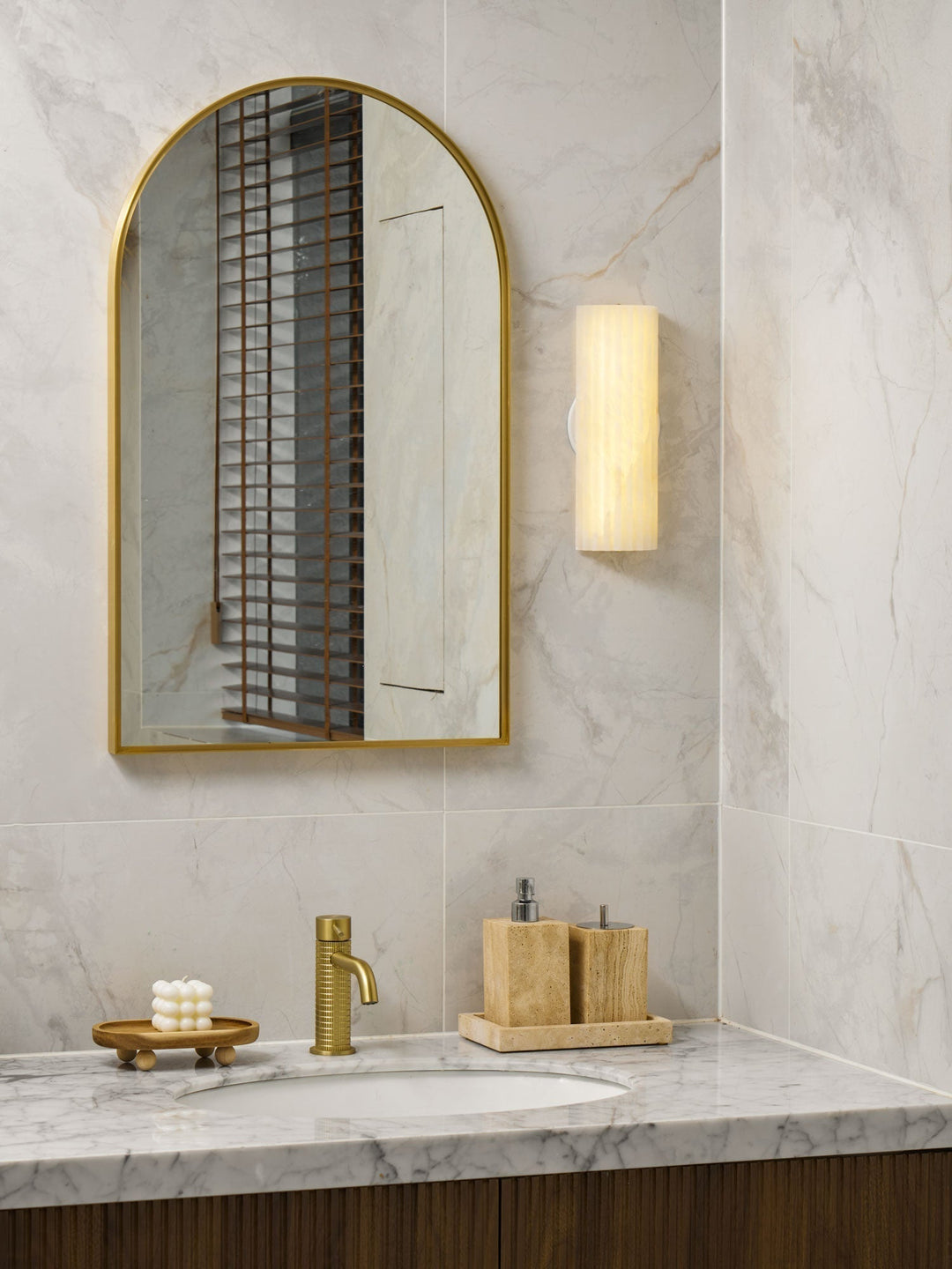 Alabaster wall sconce with integrated LED lighting, enhancing home ambiance.