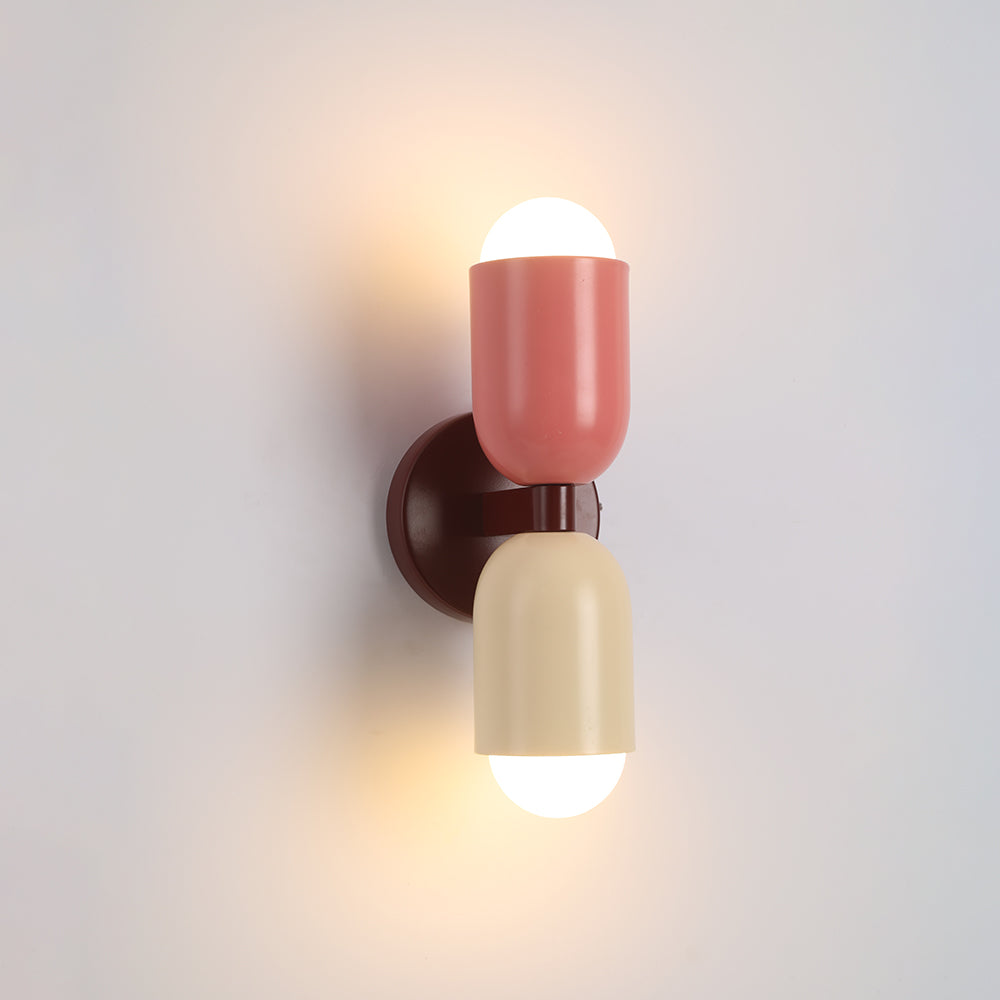 Industrial-style black cylinder LED wall light, adds a modern touch to entryways.