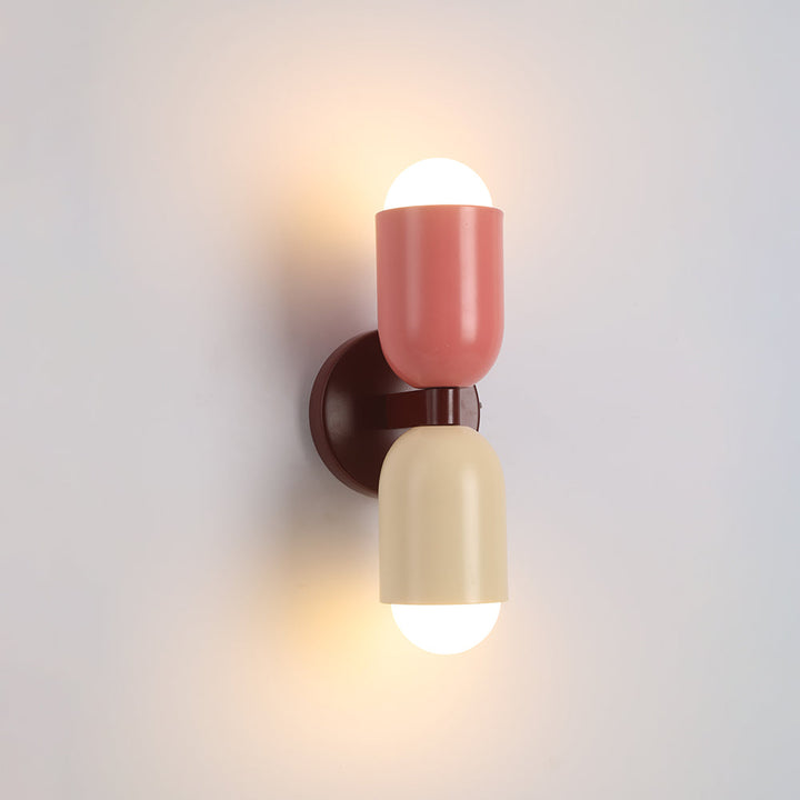 Industrial-style black cylinder LED wall light, adds a modern touch to entryways.