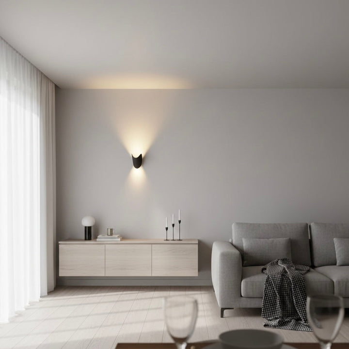 White modern LED wall sconce, providing versatile up down ambient light for hallways.