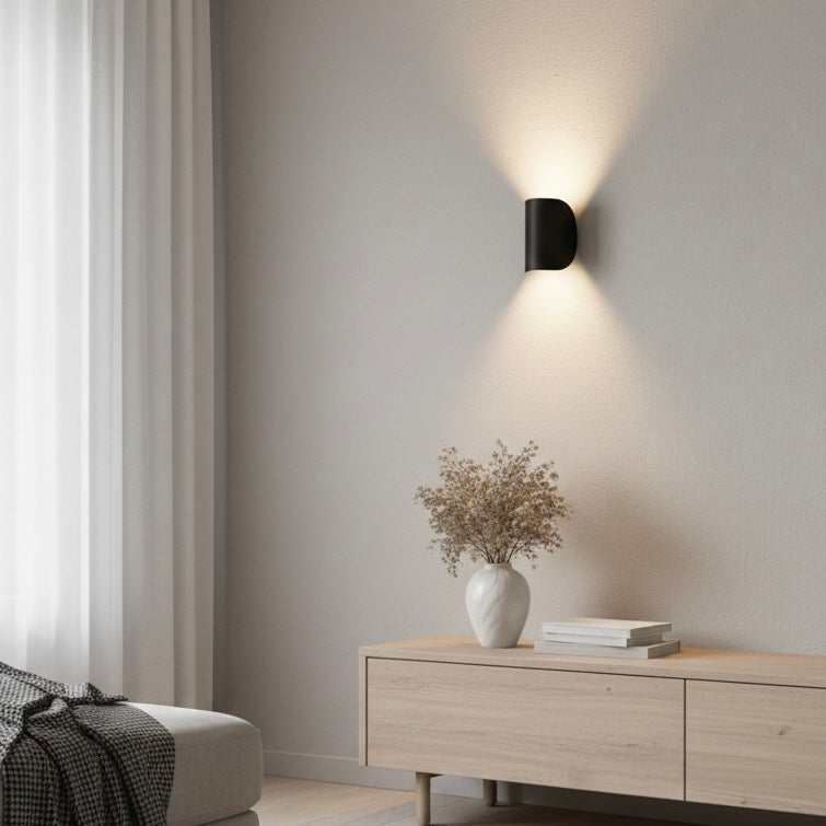 Contemporary LED up down wall fixture, enhancing home decor with its modern design and lighting.