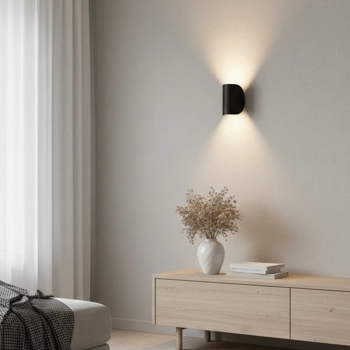 Contemporary LED up down wall fixture, enhancing home decor with its modern design and lighting.