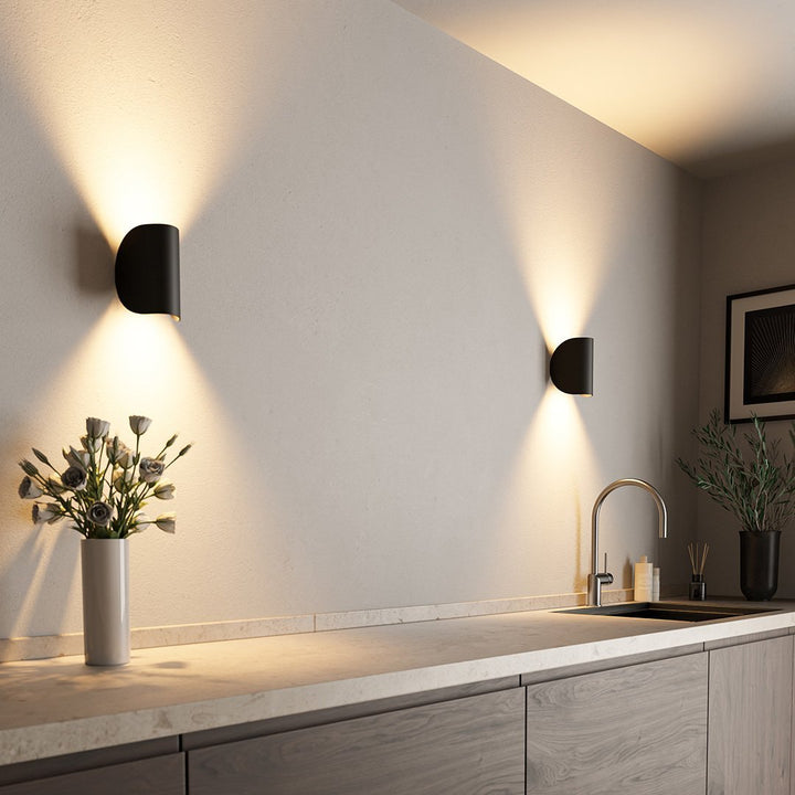 Modern black up down LED wall light, perfect for adding a sophisticated touch to outdoor areas.