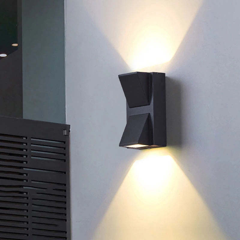 Contemporary outdoor LED wall light, weather resistant, ideal for illuminating entrances.