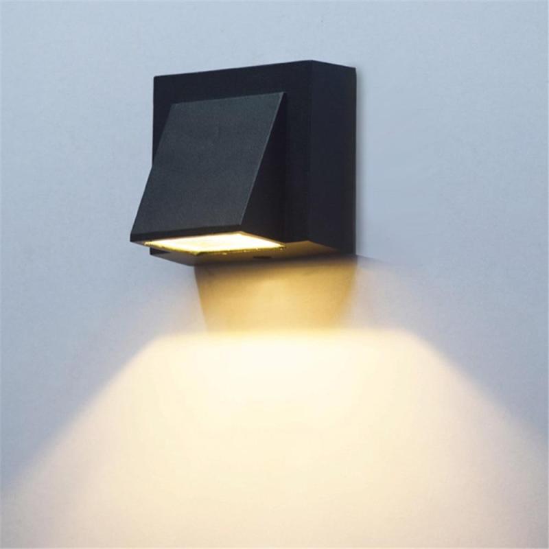 Stylish modern exterior wall fixture, grey, adds elegant lighting to pathways & patios.