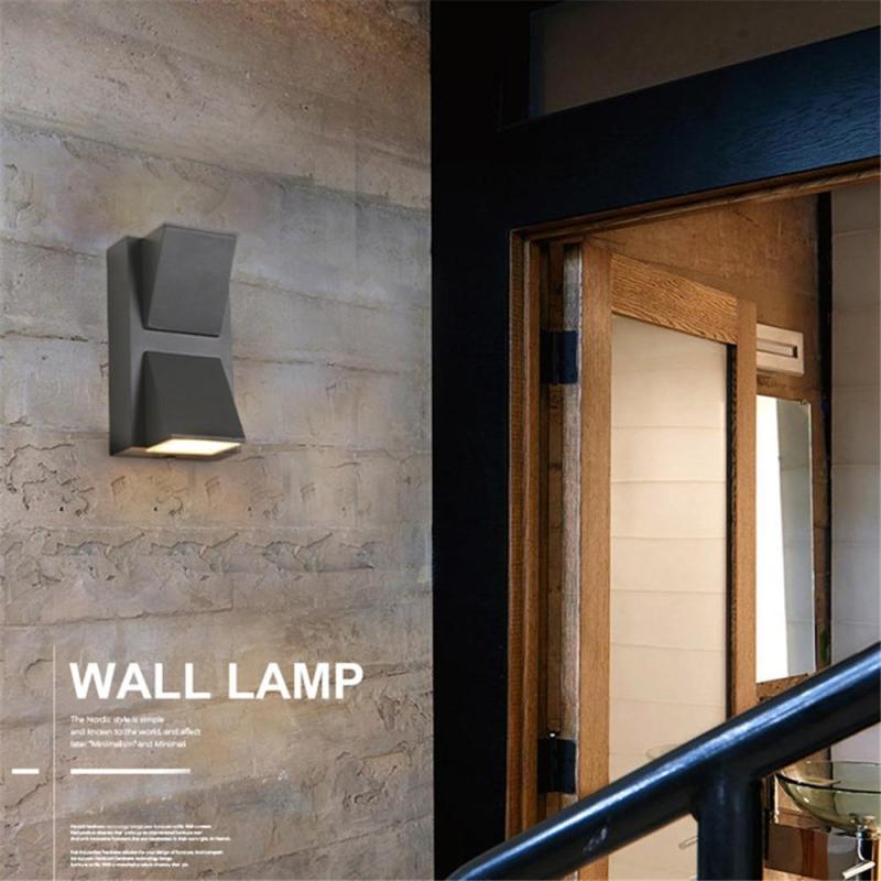 Black modern entrance wall light, energy-efficient LED, provides ample exterior illumination.