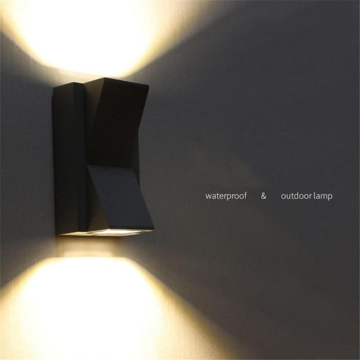 Grey outdoor wall lamp, contemporary design, ideal for pathway lighting & garden decor.