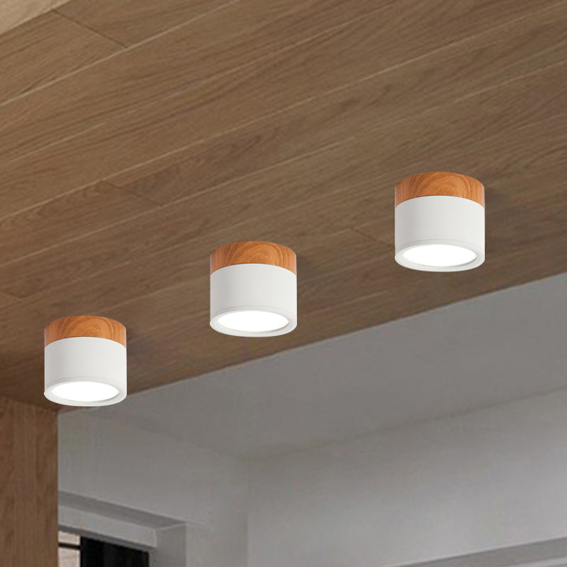 Energy-saving LED flush mount ceiling fixture in a sleek cylindrical design for modern kitchens & bars.