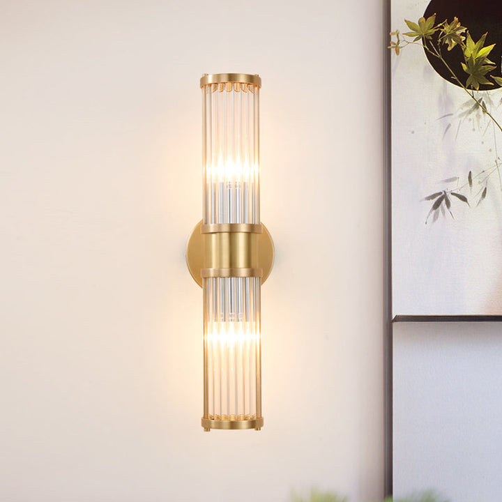 Contemporary gold wall light featuring a radiant crystal cylinder, perfect for upscale homes.