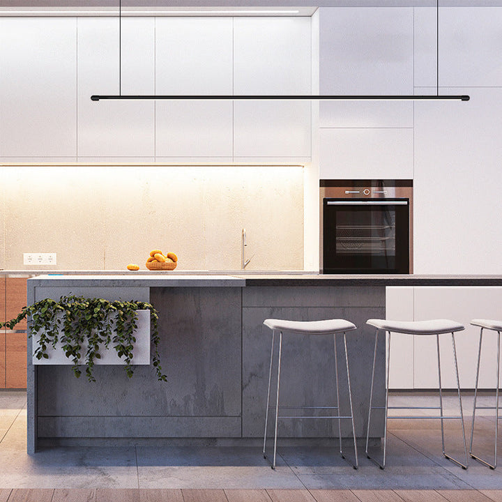 Dimmable black linear LED pendant light, modern design, ideal for kitchen island illumination.