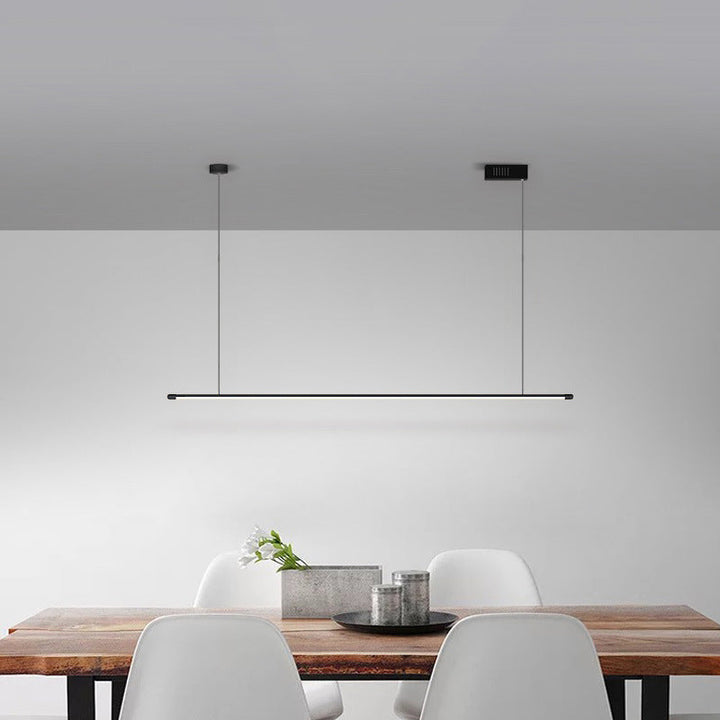 Bright, dimmable linear LED pendant light in modern black for kitchen islands.