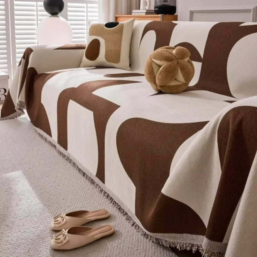 Modern geometric sofa cover in a living room, enhancing home decor & furniture protection.