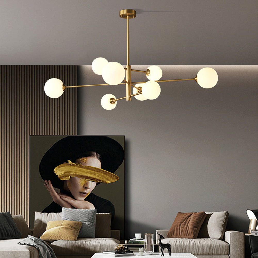 Gold finish modern globe chandelier, multi-light design illuminating a contemporary kitchen island.