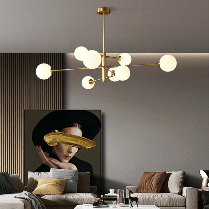Gold finish modern globe chandelier, multi-light design illuminating a contemporary kitchen island.