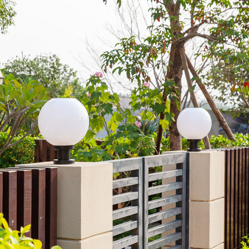 Contemporary globe post cap light for outdoor fence posts. Weather-resistant exterior garden & pathway illumination.