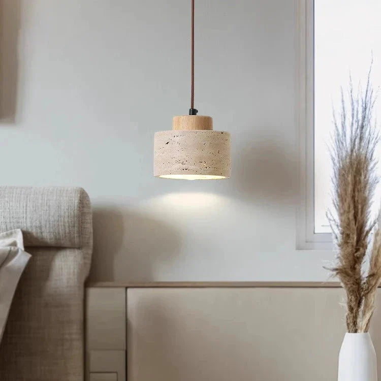 Close-up: Natural travertine texture on a modern minimalist indoor pendant light.