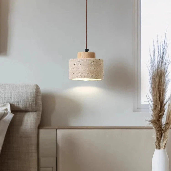 Close-up: Natural travertine texture on a modern minimalist indoor pendant light.