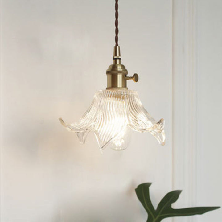 Modern industrial clear glass single pendant light, minimalist design for kitchen or dining.
