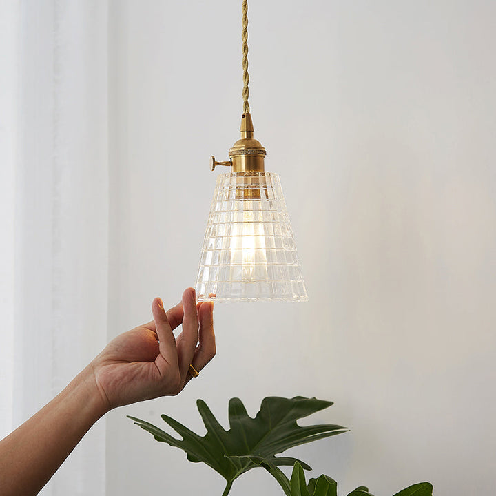 Single modern industrial clear glass pendant light, focused illumination for modern decor.