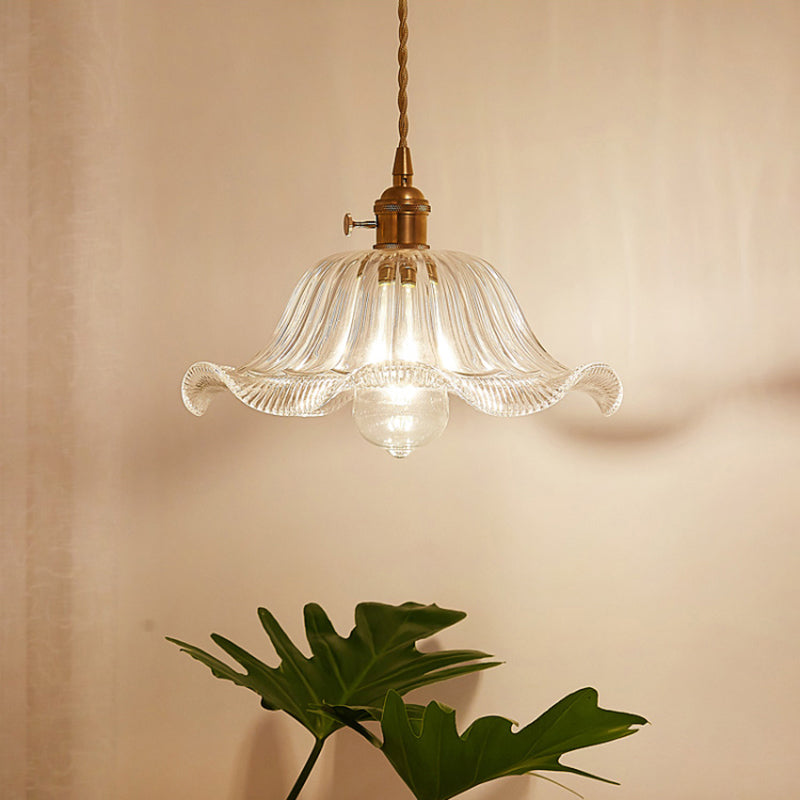 Modern industrial clear glass pendant light, perfect for cafe or restaurant lighting.