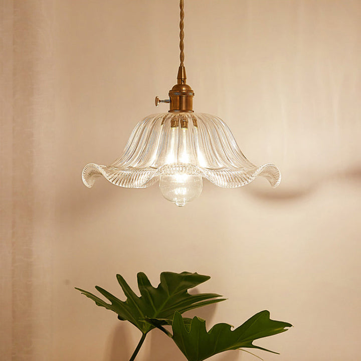 Modern industrial clear glass pendant light, perfect for cafe or restaurant lighting.