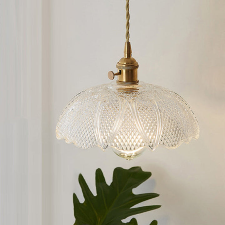 Clear glass modern industrial hanging lamp over a kitchen island, contemporary design.